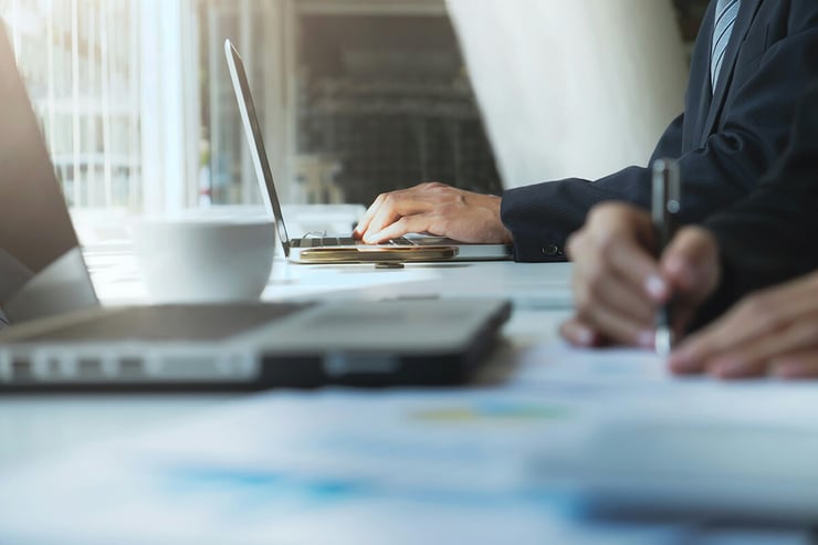 Two lawyers equipped with their devices, collaborating on a case, showcasing the benefits of robust IT support for effective communication, data security, and enhanced productivity.