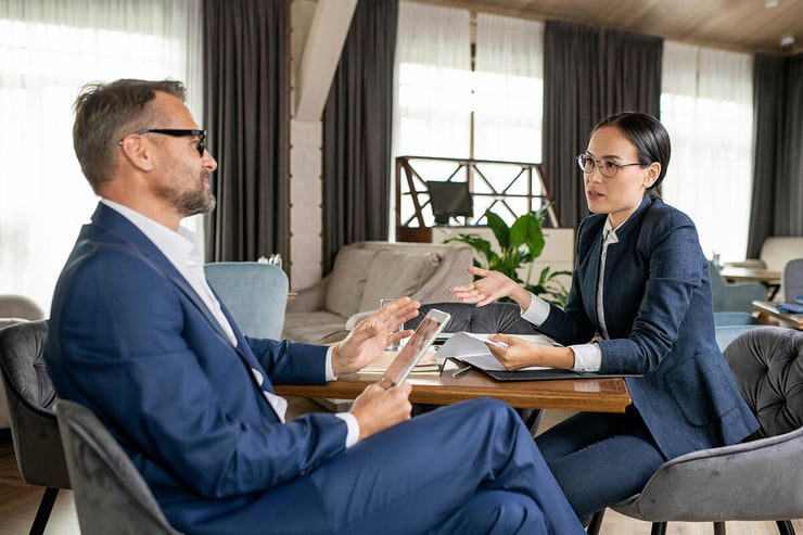 Two lawyers using their devices to work together on a case, highlighting the role of reliable IT support in enabling efficient collaboration and secure information sharing.