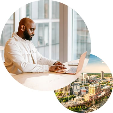 Employee in an office typing on his laptop and focusing intently on his work