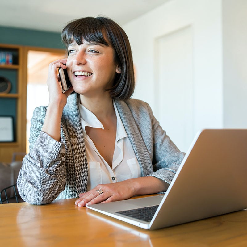 Picture of employee multitasking in the office, securely accessing SaaS apps on her computer and managing tasks on the phone, empowered by Microsoft Entra Internet Access. With best-in-class security and seamless access to Microsoft 365 apps, productivity is boosted for any user, anywhere.