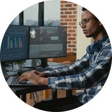 A male IT security engineer uses a SIEM tool implemented after Synergy Technical helped build a roadmap for the organization to efficiently and securely monitor potential threats.