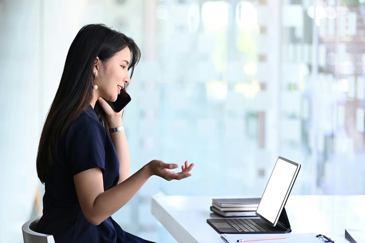 A female employee is seen hosting a Microsoft Teams webinar and using Microsoft's new verification feature to ensure all attendees are legitimate, providing a secure and private experience.