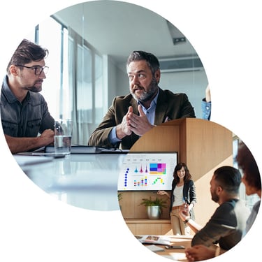 A male and female IT consultant from (IT consulting firm) lead a Cloud Security Assessment in a conference room, reviewing the client’s cloud environment on a large display, identifying vulnerabilities, and collaborating with their team to develop a strategic roadmap with recommendations and next steps to enhance security and ensure compliance.