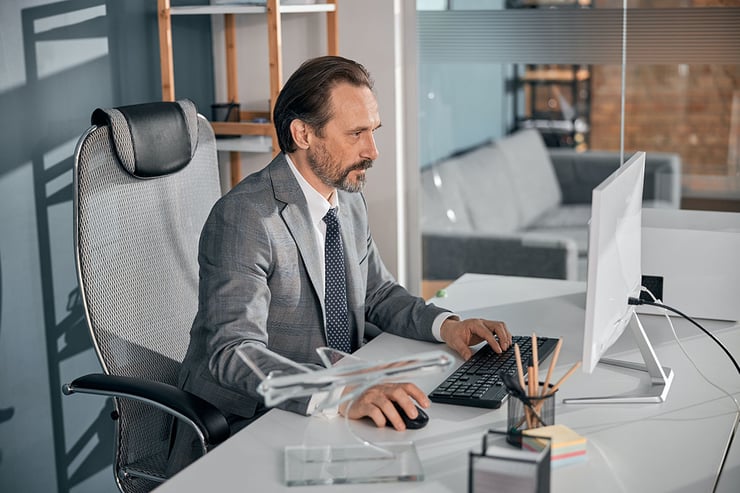 Picture of employee in an office taking effective security measures to reduce the risk of cyber incidents.