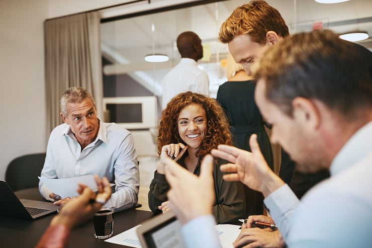 Picture of employee collaborating on a project in the office using ChatGPT, the artificial intelligence tool, to gather essential details for segmentation, such as city, state, and industry, expediting data acquisition, eliminating manual searches, and freeing up valuable time for strategic planning of campaigns.