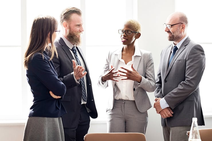 A team of employees gathers in a conference room, discussing how their organization has evolved with Microsoft 365 tools, made possible by their partnership with a Microsoft CSP, which has provided tailored licensing, expert guidance, and scalable solutions to support their growth and productivity.