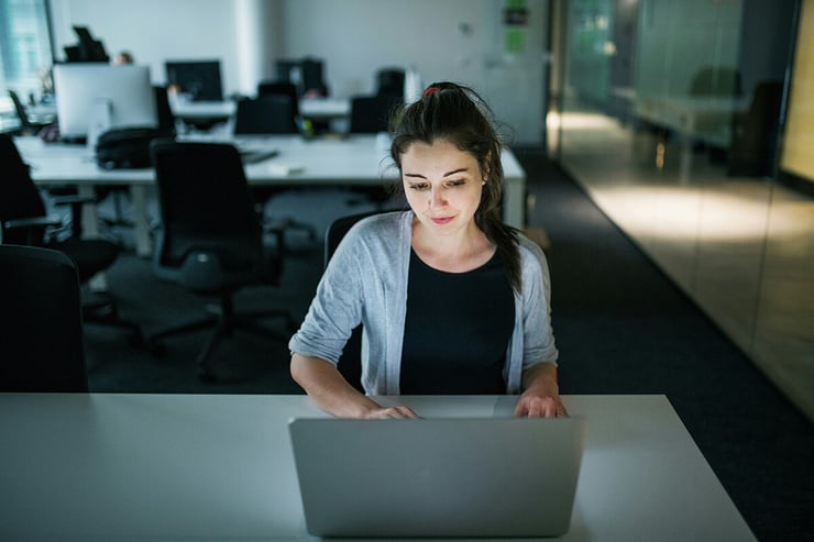 An employee in an organization working on her laptop.