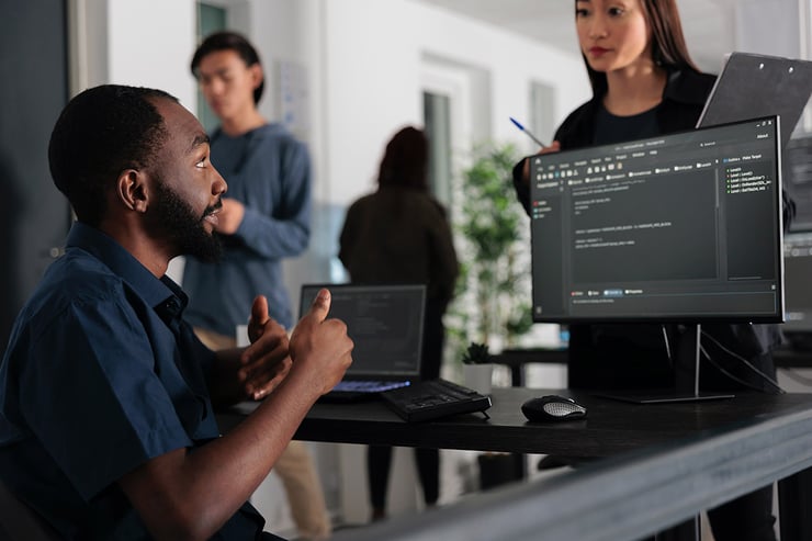 Picture of employees in the office collaborating on a project that used generative AI to come up with ideas.