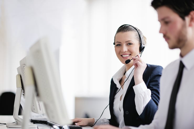 Female IT support desk with headphones providing support to customers.