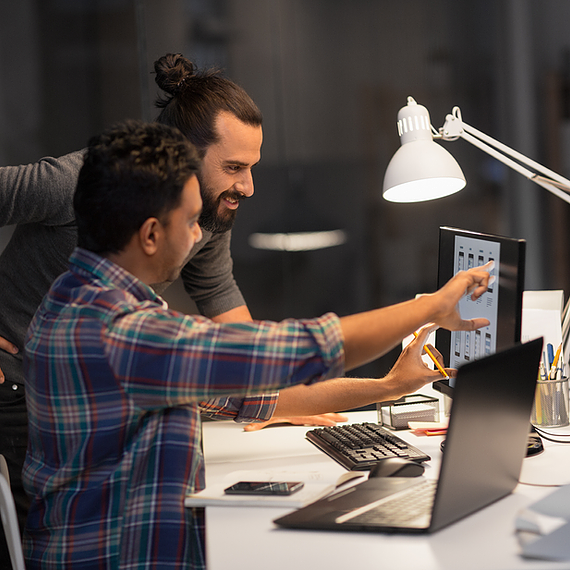 An employee is showing his manager what he has learned about recognizing security threats.