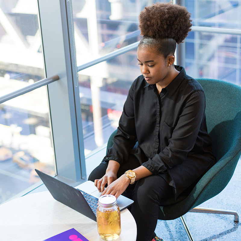 Picture of an employee in a downtown office accessing work applications seamlessly and securely with Microsoft Entra