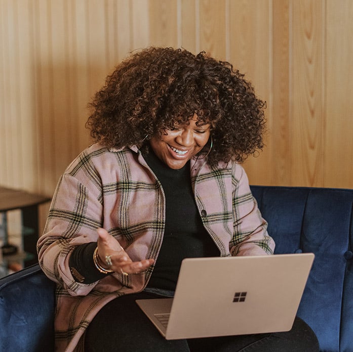 Picture of an employee working from home accessing work applications seamlessly and securely with Microsoft Entra