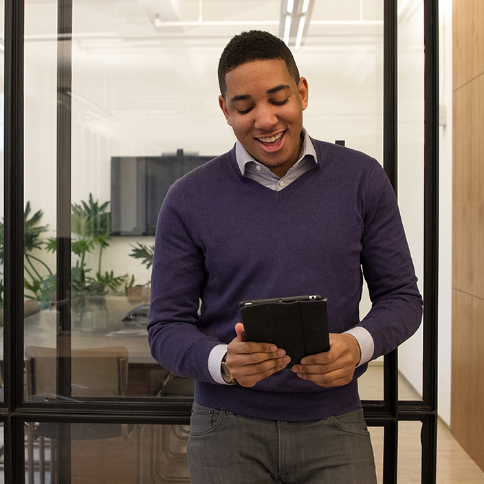 Picture of an employee in a satellite office accessing work applications seamlessly and securely with Microsoft Entra