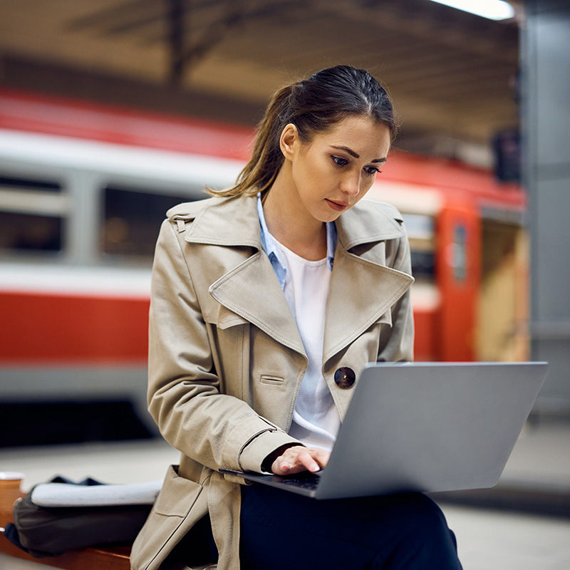 Picture of an employee working while commuting at the train station, accessing workload applications securely through the organization's identity and access management solution, Microsoft Entra ID Governance—leveraging intelligent access decisions through machine learning, with recurring reviews ensuring ongoing validation of user, group membership, and access needs.