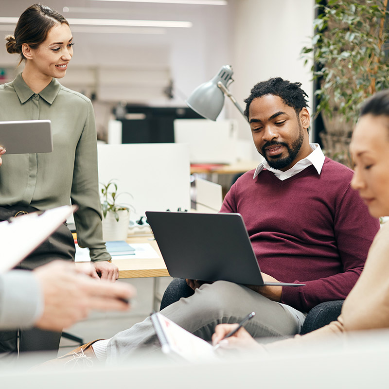 Picture of an employee collaborating seamlessly with another, accessing workload applications securely through the organization's identity and access management solution, Microsoft Entra ID Governance—balancing security and productivity, ensuring the right people have the right access to the right resources with streamlined processes and visibility.