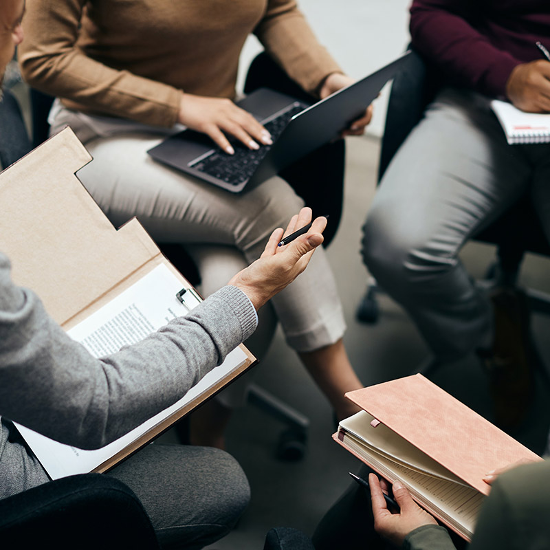 Picture of an employee seamlessly collaborating with another, accessing workload applications securely through the organization's identity and access management solution, Microsoft Entra ID Governance—balancing security and productivity, where Microsoft Entra ID enforces Conditional Access policies for controlled and secure application access.