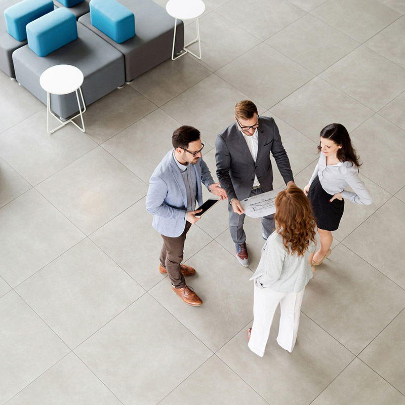 An employee meets with his team to discuss upcoming meeting agendas and projects, and to determine what they need to best prepare in advance. 