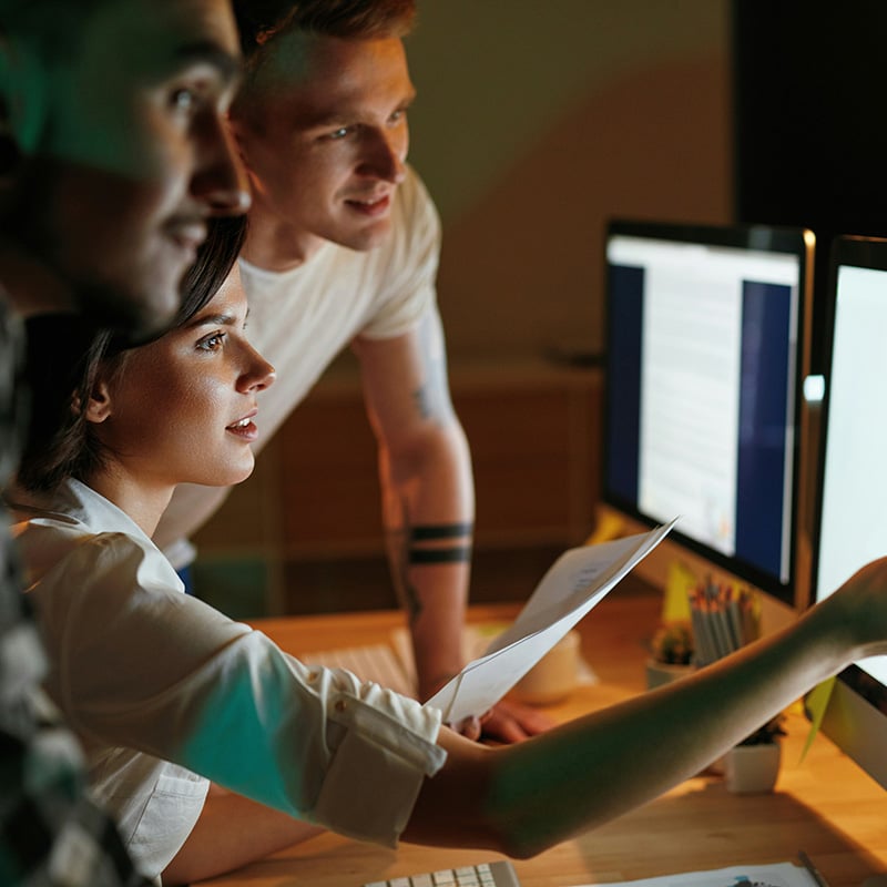 Employees in a finance firm analyzing charts on a graph securely and efficiently.