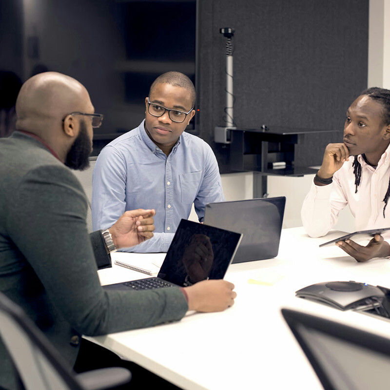 Man leading a strategic meeting with key stakeholders, demonstrating how Entra Workload ID facilitates regular reviews of workload identities in privileged roles, significantly reducing the risk associated with outdated role assignments and enhancing overall security compliance.