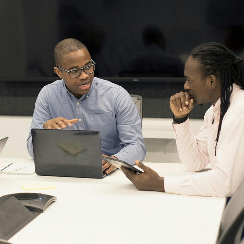 Man conducting a meeting with key stakeholders, illustrating how Entra Workload ID streamlines the periodic review and adjustment of workload identities in privileged roles to maintain security integrity and minimize risk from outdated permissions.